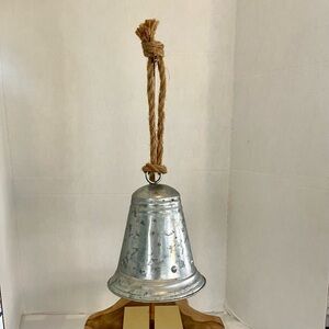 Galvanized metal hanging bell with chunky rope hanger.